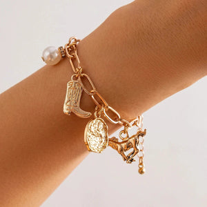 Chunky guldhalsband och armband med western-berlocker
